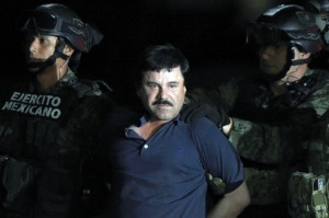 TOPSHOT - Drug kingpin Joaquin "El Chapo" Guzman is escorted into a helicopter at Mexico City's airport on January 8, 2016 following his recapture during an intense military operation in Los Mochis, in Sinaloa State. Mexican marines recaptured fugitive drug kingpin Joaquin "El Chapo" Guzman on Friday in the northwest of the country, six months after his spectacular prison break embarrassed authorities. AFP PHOTO / ALFREDO ESTRELLA / AFP / ALFREDO ESTRELLA